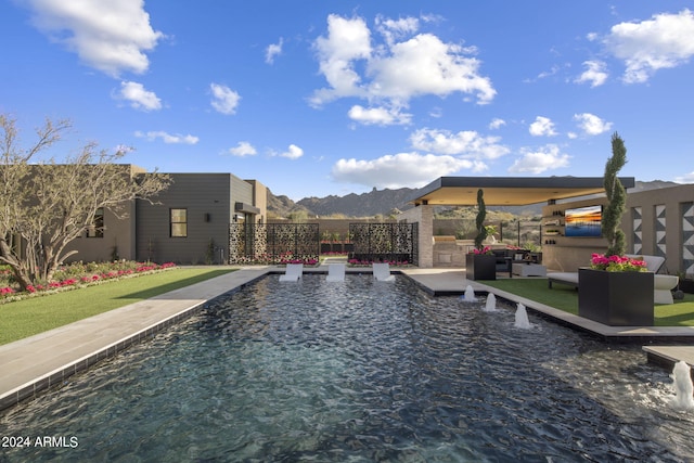 view of swimming pool featuring outdoor lounge area and a mountain view