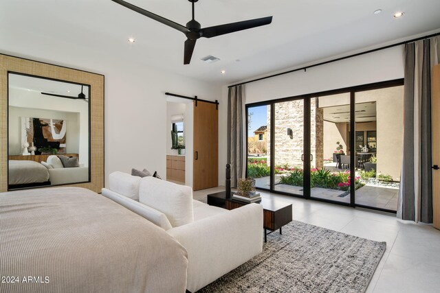 bedroom featuring access to exterior, a barn door, and ceiling fan