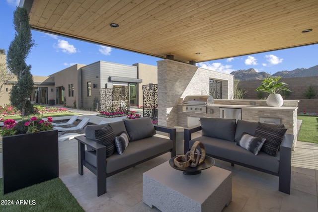 view of patio featuring a mountain view, an outdoor living space, area for grilling, and grilling area