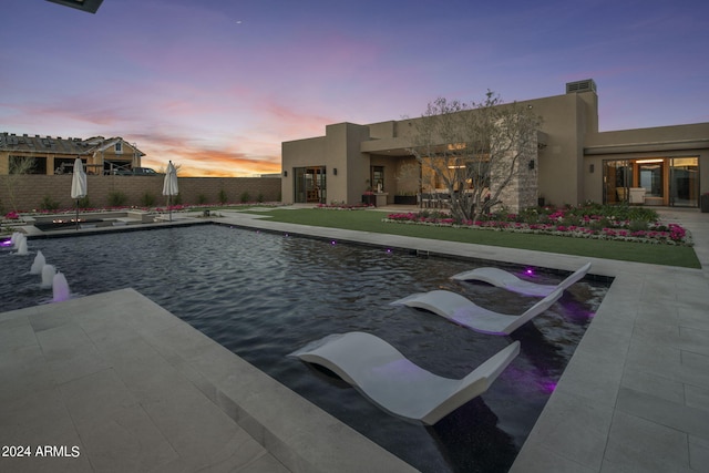 view of pool at dusk