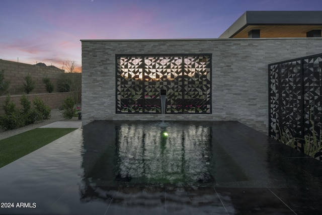 view of patio terrace at dusk