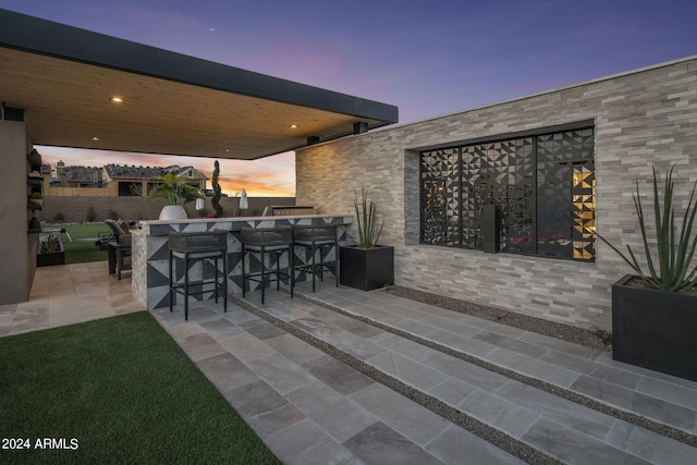 patio terrace at dusk with a bar