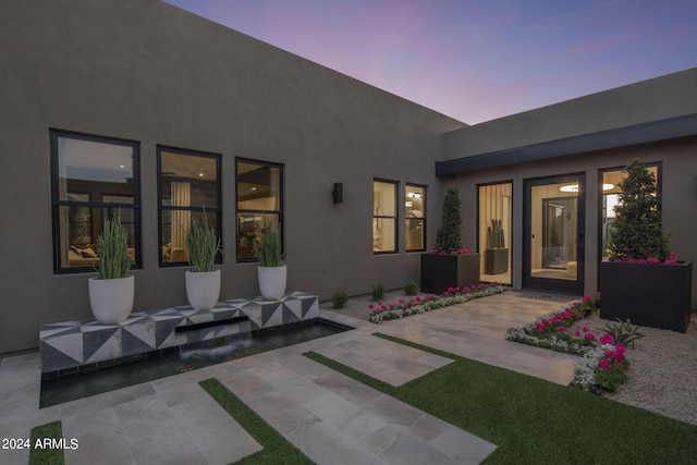 view of patio terrace at dusk