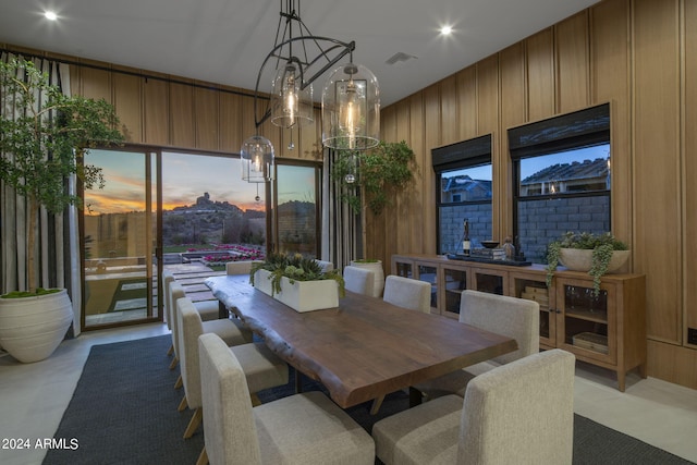 dining area featuring wood walls