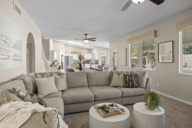 living room with vaulted ceiling, carpet flooring, a wealth of natural light, and ceiling fan