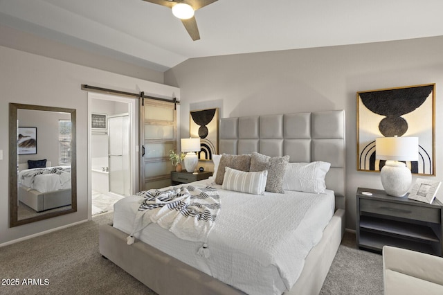 carpeted bedroom featuring ceiling fan, ensuite bath, a barn door, and vaulted ceiling