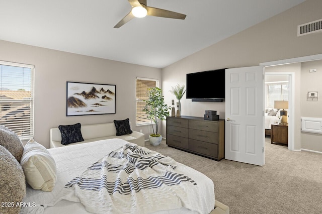 bedroom with lofted ceiling, light carpet, and ceiling fan