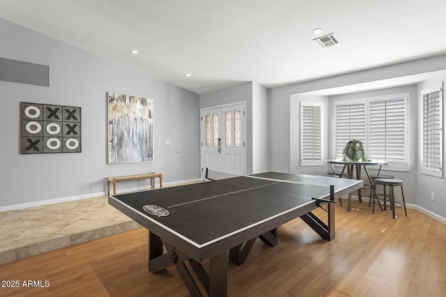 game room featuring vaulted ceiling and light hardwood / wood-style floors