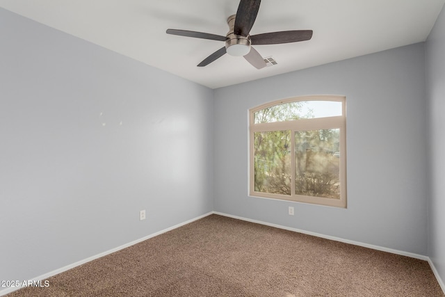 empty room with ceiling fan and carpet