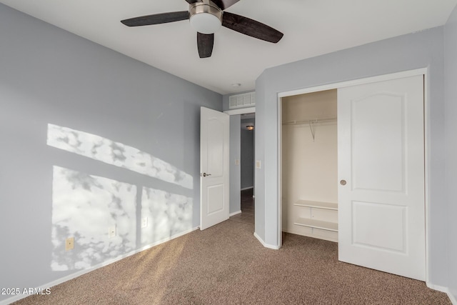 unfurnished bedroom with carpet floors, a closet, and ceiling fan