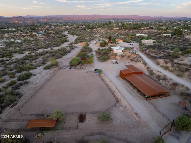 aerial view at dusk featuring a mountain view