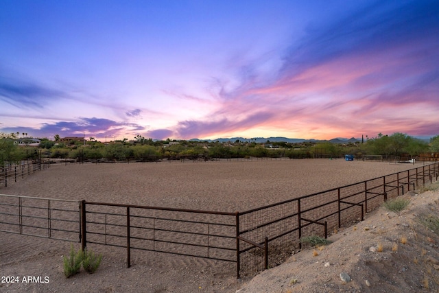 yard at dusk with a rural view