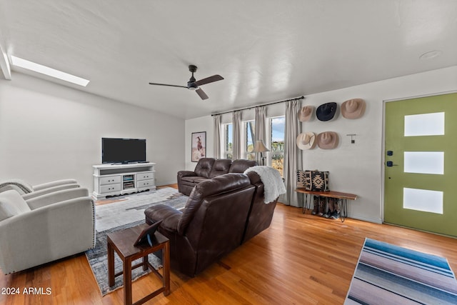 living room with ceiling fan and light hardwood / wood-style floors