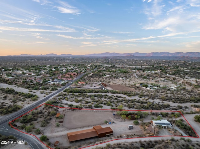 aerial view at dusk featuring a mountain view