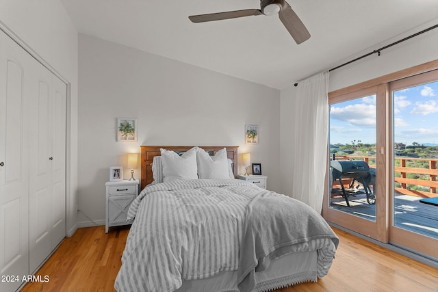 bedroom featuring access to outside, light wood-type flooring, a closet, and ceiling fan