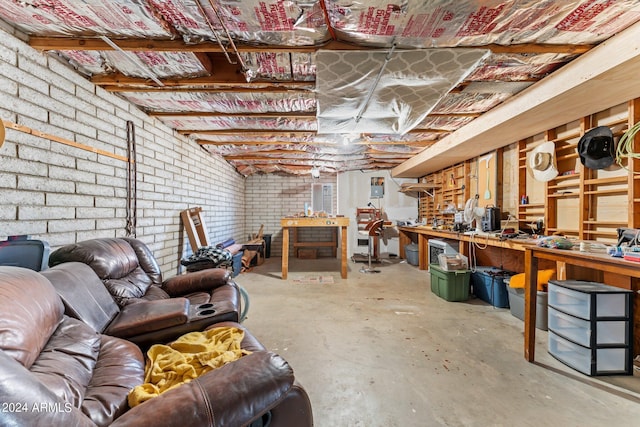 basement with a workshop area and brick wall