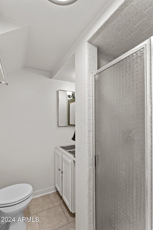 bathroom with tile patterned flooring, walk in shower, vanity, and toilet