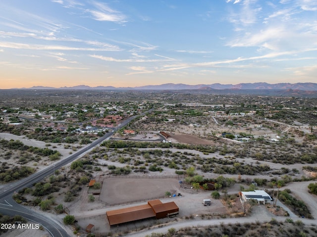 aerial view at dusk featuring a mountain view