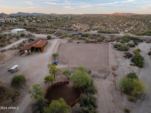 aerial view at dusk featuring a mountain view