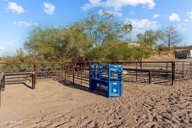 view of horse barn with a rural view