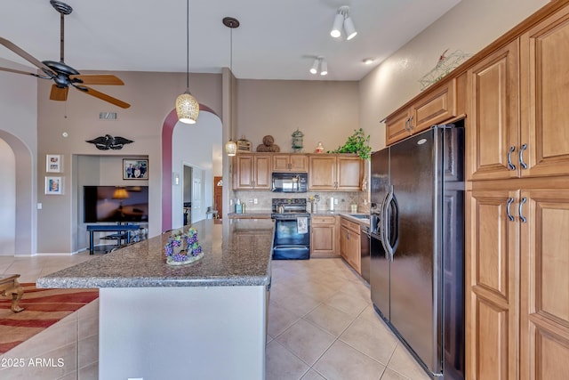 16230 E Glenpoint Dr, Fountain Hills, AZ 85268 - kitchen featuring black appliances, ceiling fan, arched walkways, light tile patterned floors, and a high ceiling