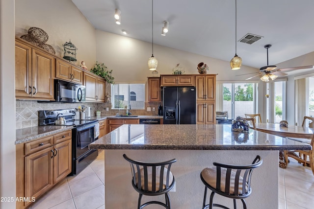 16230 E Glenpoint Dr, Fountain Hills, AZ 85268 - kitchen featuring light tile patterned floors, visible vents, a sink, a kitchen island, and black appliances
