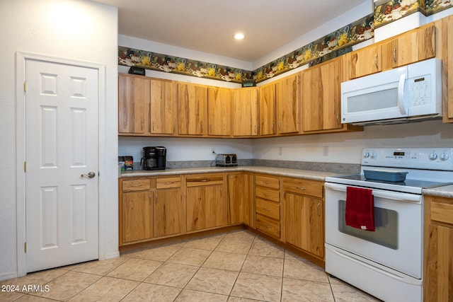 kitchen with white appliances and light tile patterned floors