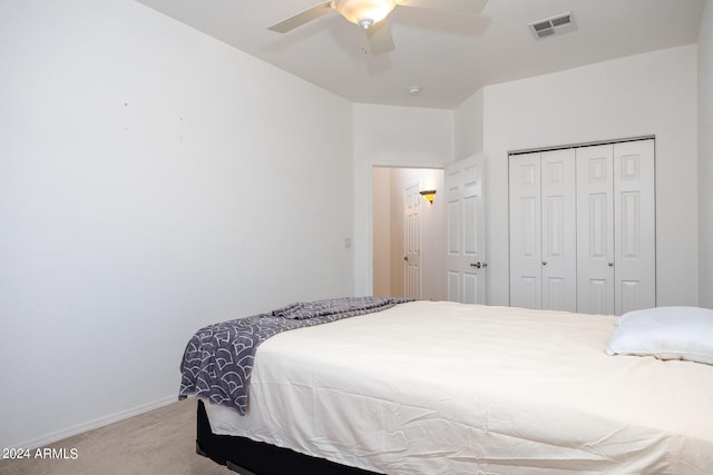 carpeted bedroom with a closet and ceiling fan