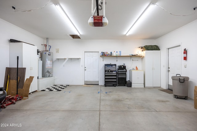 garage with gas water heater and a garage door opener