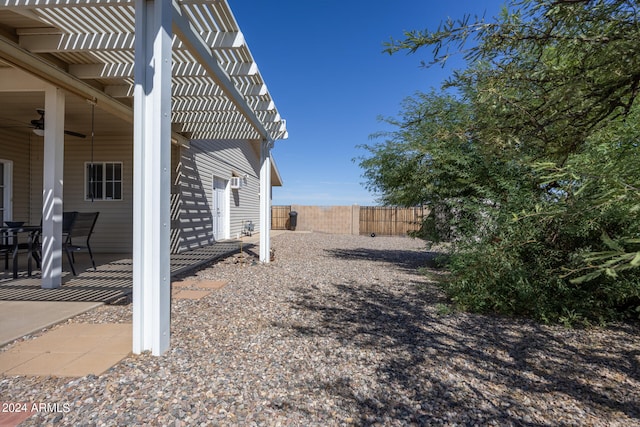 view of yard with a pergola, ceiling fan, and a patio