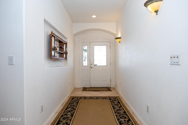 doorway to outside featuring light tile patterned flooring