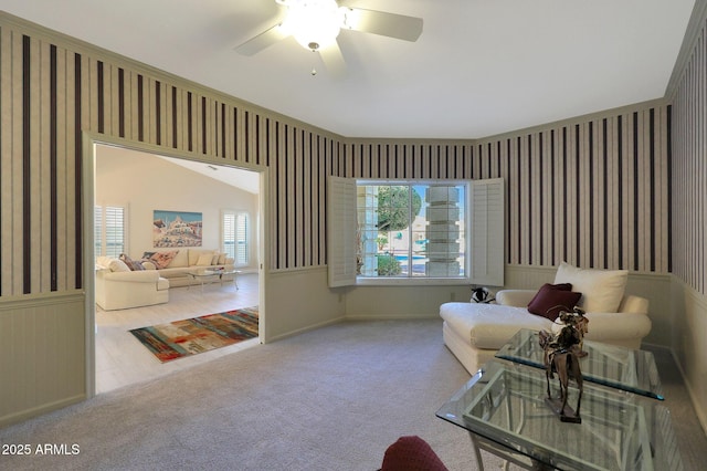 living area featuring ceiling fan and light colored carpet