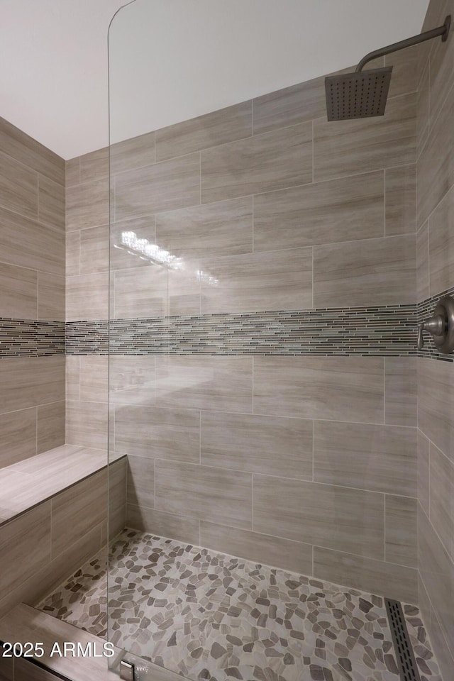 bathroom with tiled shower