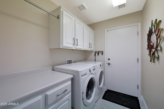 laundry area with cabinets and separate washer and dryer