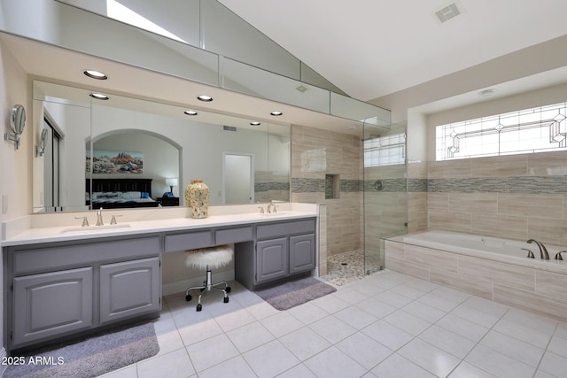 bathroom with lofted ceiling, vanity, tile patterned floors, and independent shower and bath