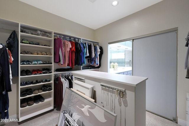 walk in closet with light carpet and radiator heating unit