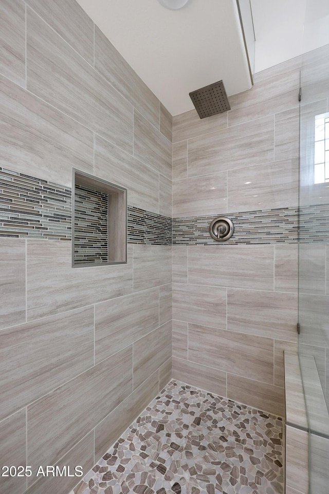 bathroom with tiled shower