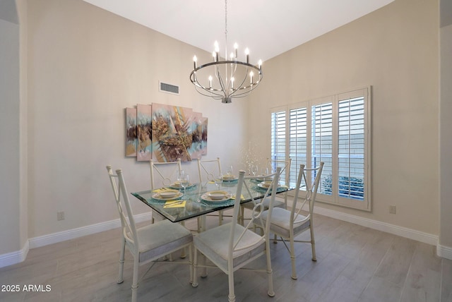 unfurnished dining area with a chandelier and light hardwood / wood-style floors