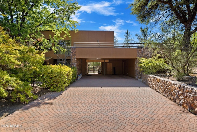 exterior space with a carport and a balcony