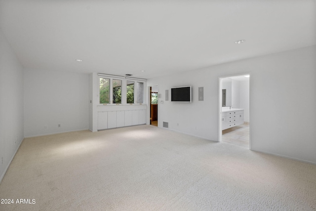 spare room featuring light colored carpet