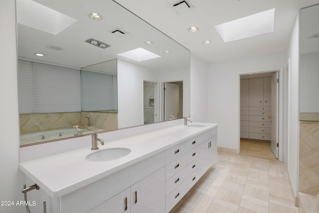 bathroom with a skylight and vanity