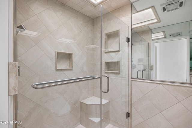 bathroom with a shower with shower door