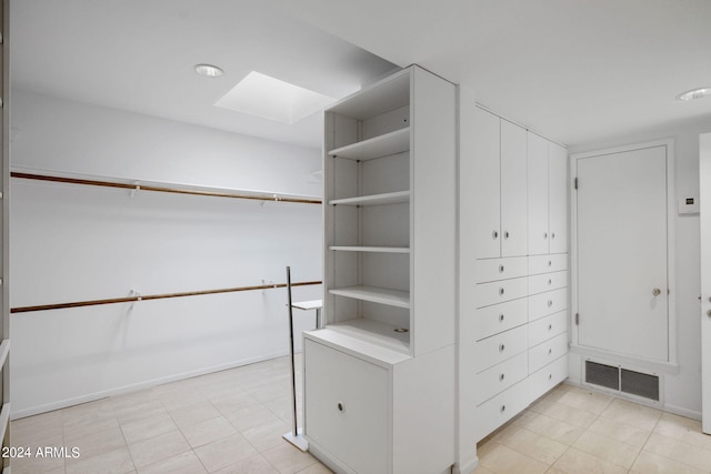 spacious closet featuring a skylight