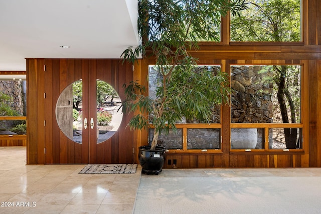 entryway featuring wood walls