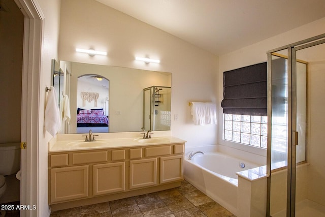 full bathroom with plus walk in shower, vaulted ceiling, vanity, and toilet