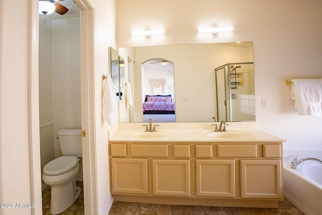 full bathroom with ceiling fan, vanity, toilet, and plus walk in shower