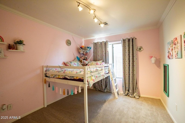 bedroom with carpet floors, ornamental molding, and rail lighting