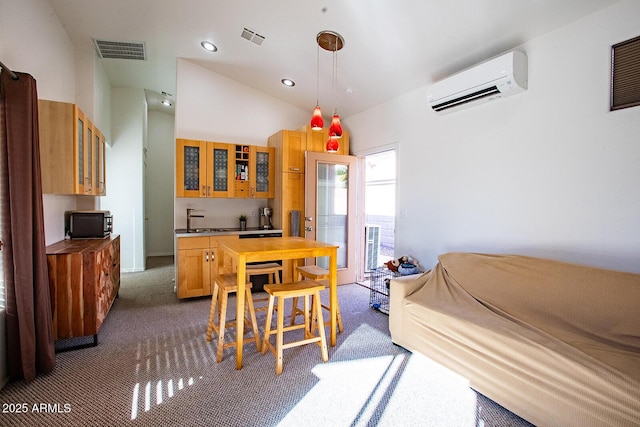 dining area featuring vaulted ceiling, dark carpet, sink, and a wall unit AC