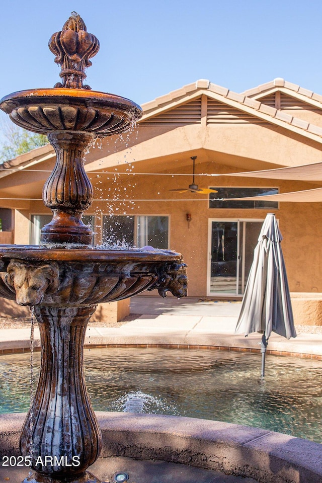 exterior space with ceiling fan and a patio area