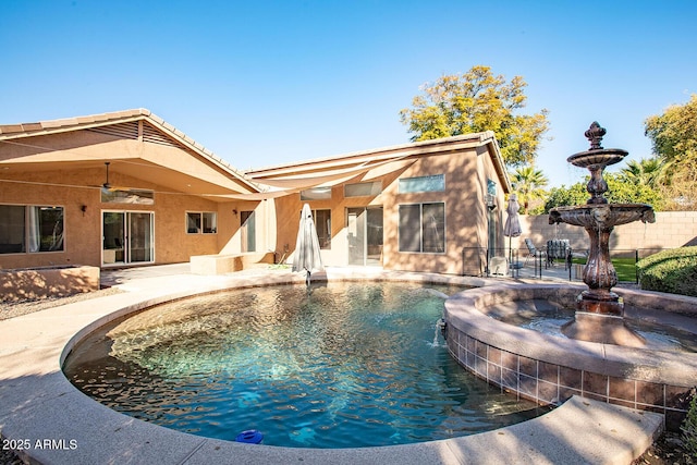 view of swimming pool featuring a patio, pool water feature, and ceiling fan